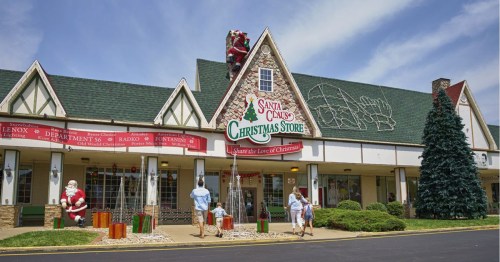 A festive Christmas store with decorations, featuring Santa and a large sign that reads "Santa Claus Christmas Store."