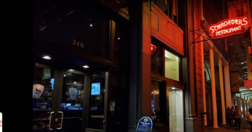 Exterior of Schroeder's Restaurant at night, featuring a glowing red sign and large glass windows.