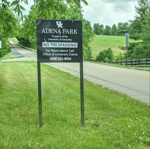 Sign for Adena Park, University of Kentucky, stating "No Trespassing" with contact info for reservations.
