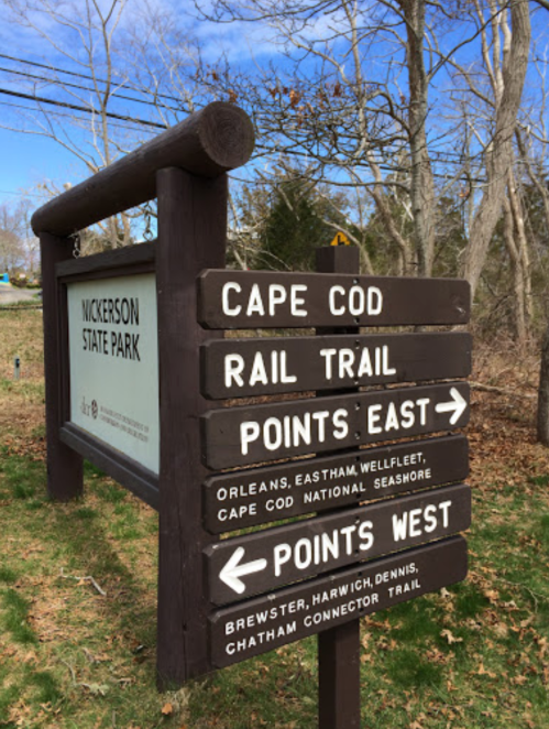 Signpost at Nickerson State Park with directions to Cape Cod, Rail Trail, and points east and west.