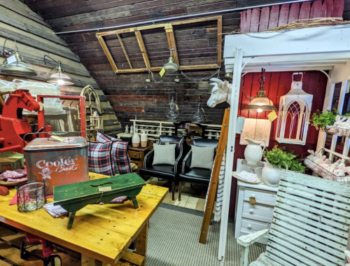 Cozy attic space with rustic decor, featuring wooden furniture, vintage items, and warm lighting.