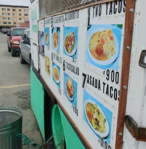 Menu board on a food truck displaying various Mexican dishes and prices, including tacos and burritos.