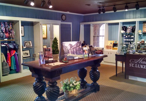 A cozy gift shop interior with a wooden counter, shelves of merchandise, and blue walls.