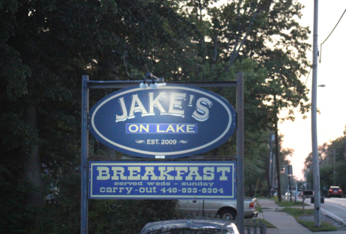 Sign for Jake's on Lake, established in 2009, advertising breakfast and carry-out services.