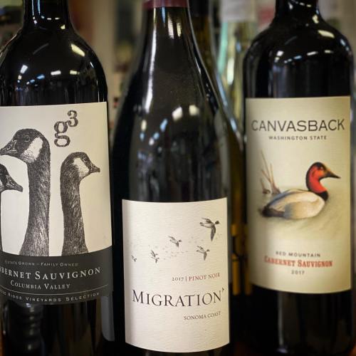 Three wine bottles with distinct labels: g3 Cabernet Sauvignon, Migration Pinot Noir, and Canvasback Cabernet Sauvignon.