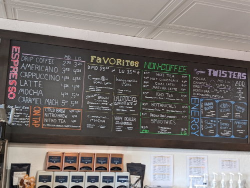 Chalkboard menu featuring espresso, non-coffee drinks, and smoothies with prices listed for each item.