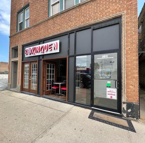 Exterior of a restaurant named "Borinquen," featuring large windows and a welcoming entrance.