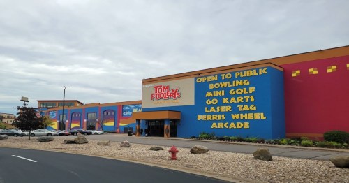 Colorful exterior of a family entertainment center featuring bowling, mini golf, go-karts, and more.