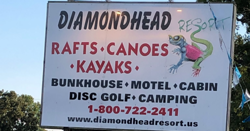 Sign for Diamondhead Resort featuring activities like rafting, canoeing, kayaking, and accommodations. Contact info included.