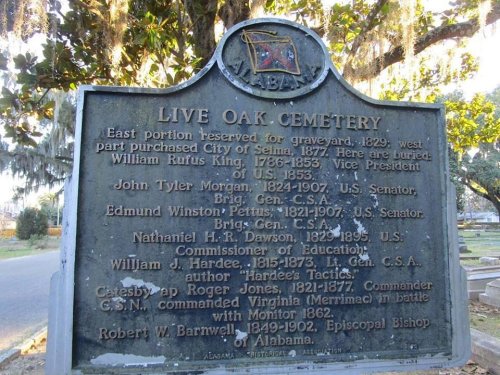 Sign at Live Oak Cemetery in Alabama, listing notable figures and their contributions, with a historical context.