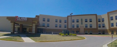 Exterior view of the 7 Clans Hotel, featuring a modern design and clear blue sky.