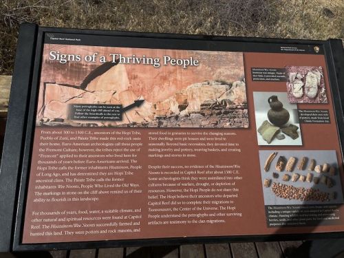Sign describing the history and culture of the Pueblo people, featuring artifacts and their connection to the land.