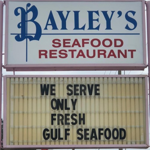 Sign for Bayley's Seafood Restaurant stating "We serve only fresh Gulf seafood."
