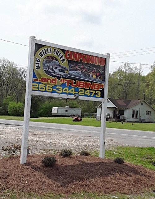 Sign for Big Wills Creek Campground, promoting camping and tubing activities, with a phone number for inquiries.