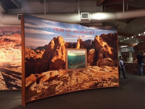 Exhibit display featuring a desert landscape with a sign reading "From an Ancient Sea: The Valley of Fire."