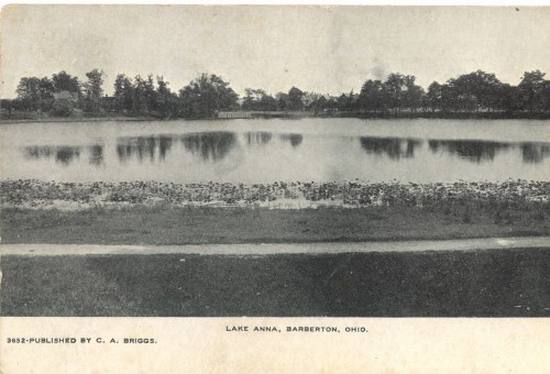 Black and white postcard of Lake Anna in Barberton, Ohio, featuring a calm lake surrounded by trees.