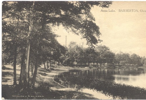 Black and white postcard of Anna Lake in Barberton, Ohio, featuring trees and a serene water view.