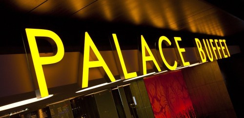 Bright yellow sign reading "PALACE BUFFET" against a dark background.