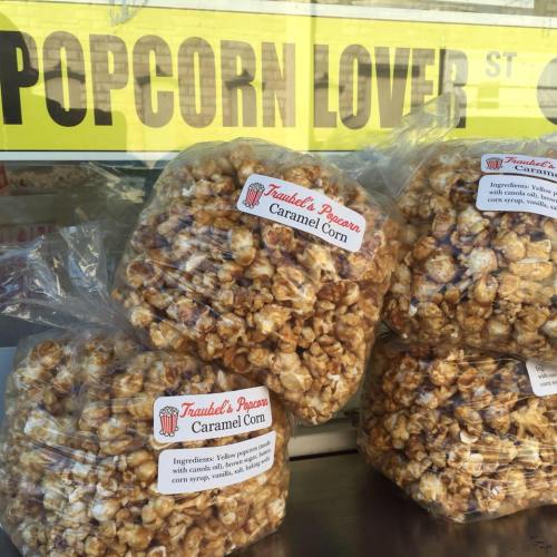 A clear bag of caramel popcorn with a label detailing ingredients and the brand name "Trautzel's Popcorn."
