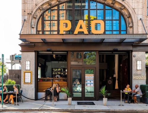 Exterior of PAO restaurant with large signage, outdoor seating, and patrons enjoying their meals on a sunny day.