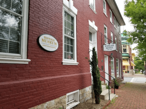 Exterior view of a red brick building featuring a museum sign and the Entler Hotel sign nearby.