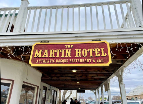 Sign for The Martin Hotel, featuring "Authentic Basque Restaurant & Bar," under a wooden awning.