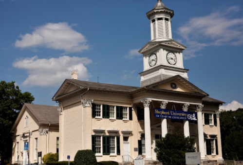 Historic building of Shepherd University with a clock tower and a banner celebrating 150 years of excellence.
