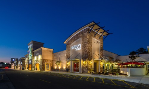 Exterior view of a restaurant named "Edgar's Grille" at dusk, featuring stone architecture and outdoor seating.