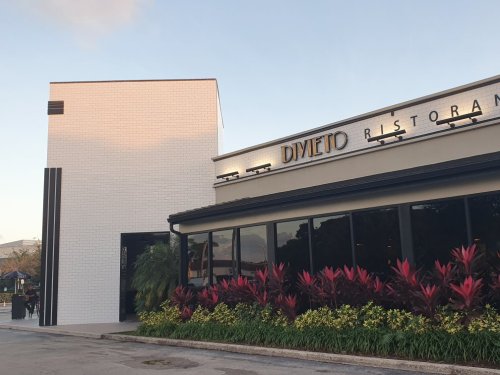 Exterior view of Divieto Ristorante, featuring modern architecture and vibrant landscaping.