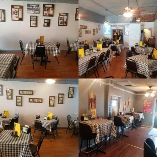 A cozy restaurant interior with checkered tablecloths, empty tables, and framed photos on the walls.