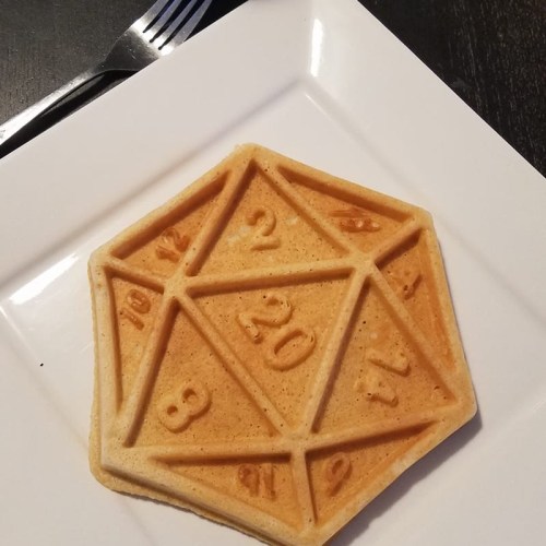A hexagonal waffle with numbers 2, 8, 12, 20, and 18 imprinted on its surface, served on a white plate.