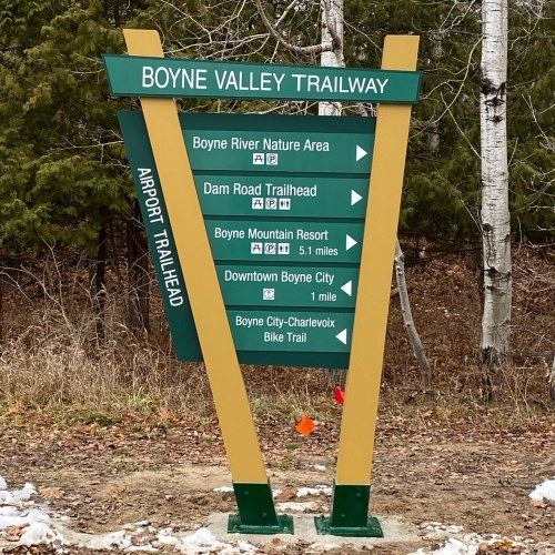 Signpost for Boyne Valley Trailway with directions to various locations, including Boyne River Nature Area and Downtown Boyne City.