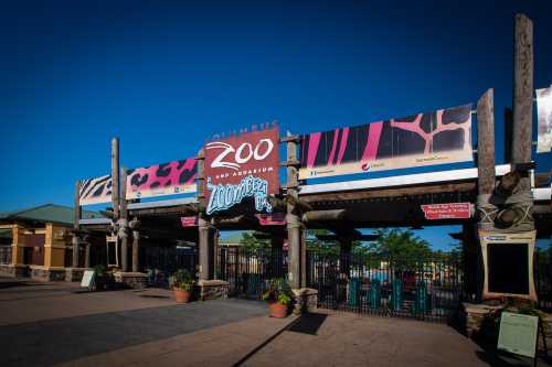 Entrance to the Columbus Zoo and Aquarium, featuring colorful signage and a clear blue sky.