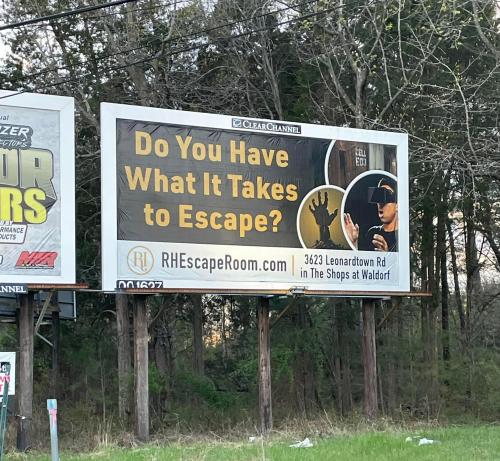 Billboard advertising an escape room with the text: "Do You Have What It Takes to Escape?" and location details.
