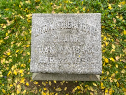 Gravestone with the inscription: "Merritt H. J. Clark, Jan 27, 1846 - Apr 22, 1893," surrounded by grass and fallen leaves.