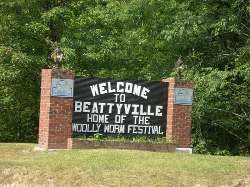 Welcome sign for Beattyville, home of the Woolly Worm Festival, surrounded by greenery.