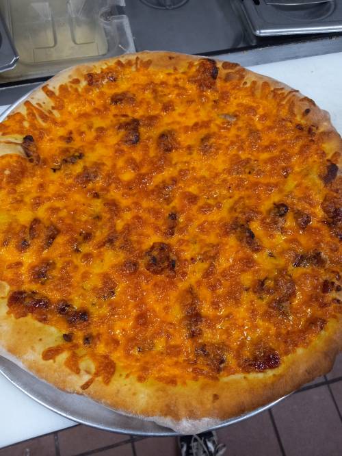 A freshly baked pizza with a golden, cheesy topping and a thick crust, placed on a metal tray.