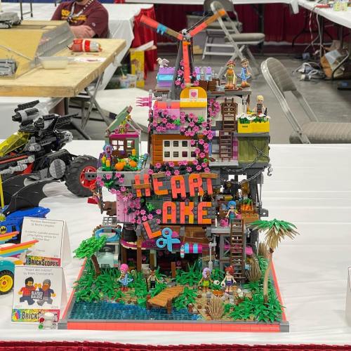 Colorful LEGO structure titled "Heart Lake," featuring various characters, plants, and a whimsical design.