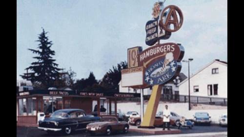Vintage fast food restaurant sign with cars parked outside, featuring hamburgers and tacos, set in a colorful scene.