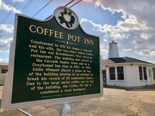 Image of the Coffee Pot Inn, a historic two-story building with a distinctive metal coffee pot on top, in Brookhaven, MS.