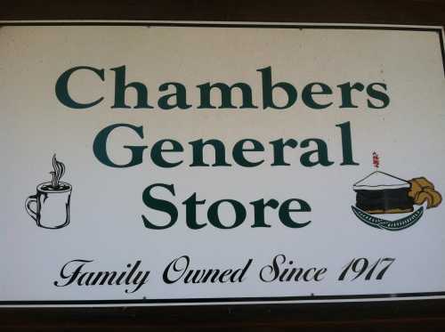 Sign for Chambers General Store, featuring a coffee cup and cake illustration, stating "Family Owned Since 1917."