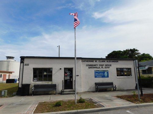 Catherine W. Clark Alexander Community Post Office in Eatonville, FL, with a flag and benches outside.