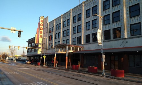Historic building with a marquee sign reading "Agora," featuring a sidewalk and street in front.