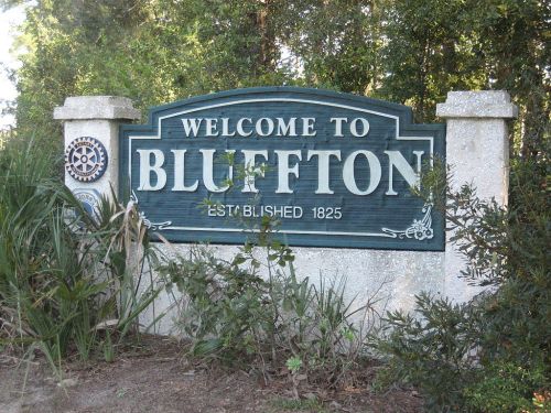 Welcome sign for Bluffton, established in 1825, surrounded by greenery.