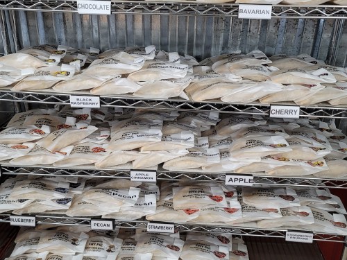 Shelves filled with various pie filling bags, including flavors like chocolate, cherry, and blueberry.
