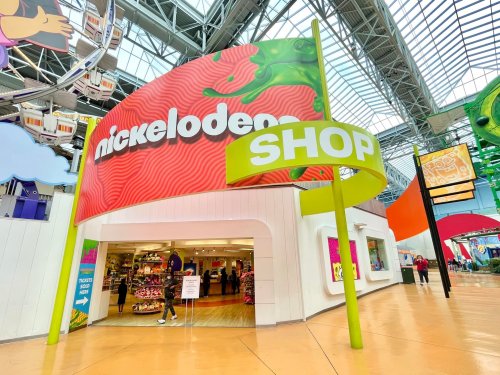 Entrance to a colorful Nickelodeon shop with vibrant signage and a bright, spacious interior.