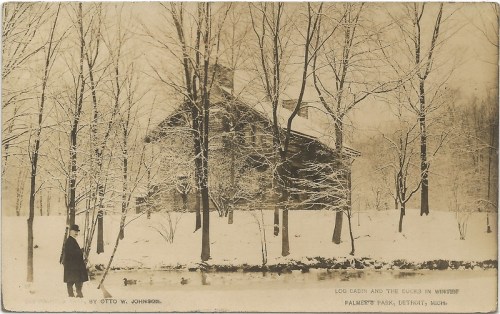 A snowy landscape featuring a log cabin and a pond, with a person standing by the water in Palmer Park, Detroit.