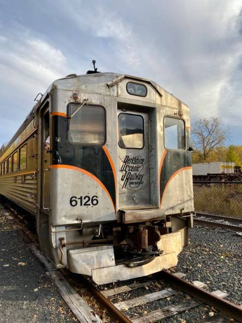 A vintage train car with the text "Berkshire Scenic Railway" on its side, parked on a railway track.