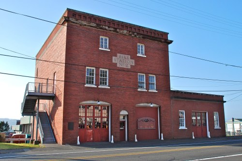 Historic red brick fire station with large windows and a sign reading "Fire Station No. 2," now a museum.