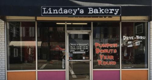 Front view of Lindsey's Bakery featuring a drive-thru and signs for pumpkin donuts available year-round.
